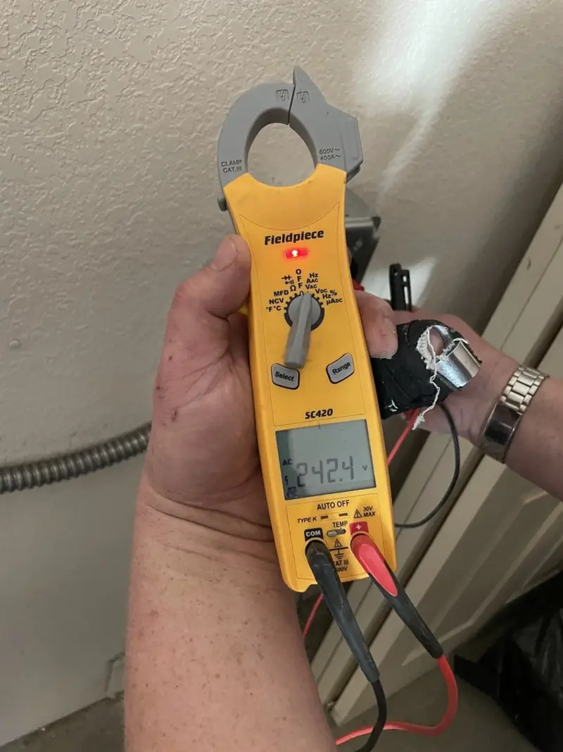 Voltage testing with clamp meter during Recessed Lighting Installation in Evansville